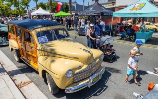 People walking around classic car show in dana point, ca