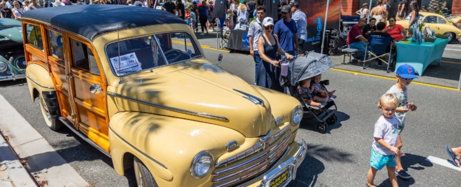 People walking around classic car show in dana point, ca