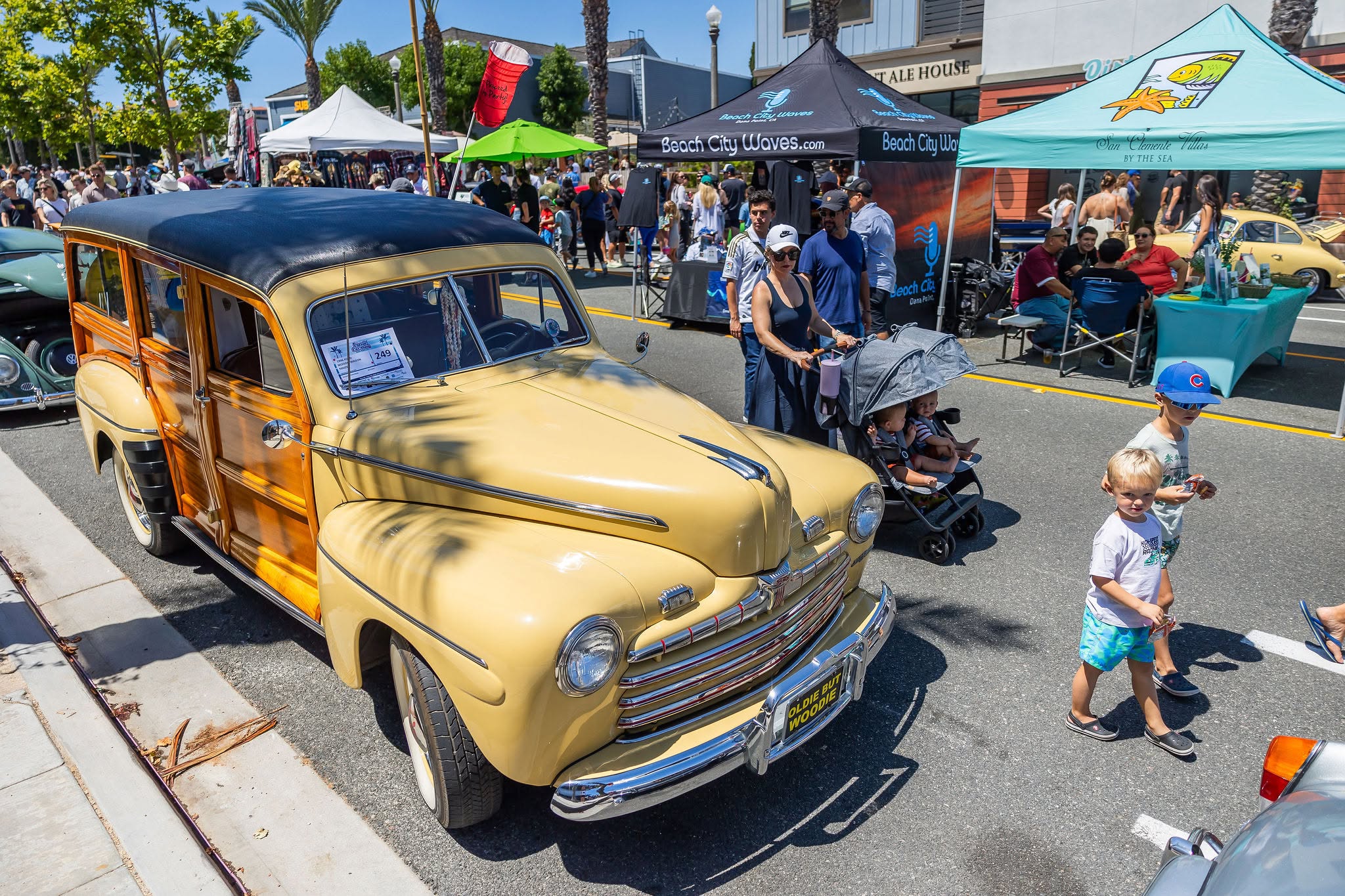 People walking around classic car show in dana point, ca